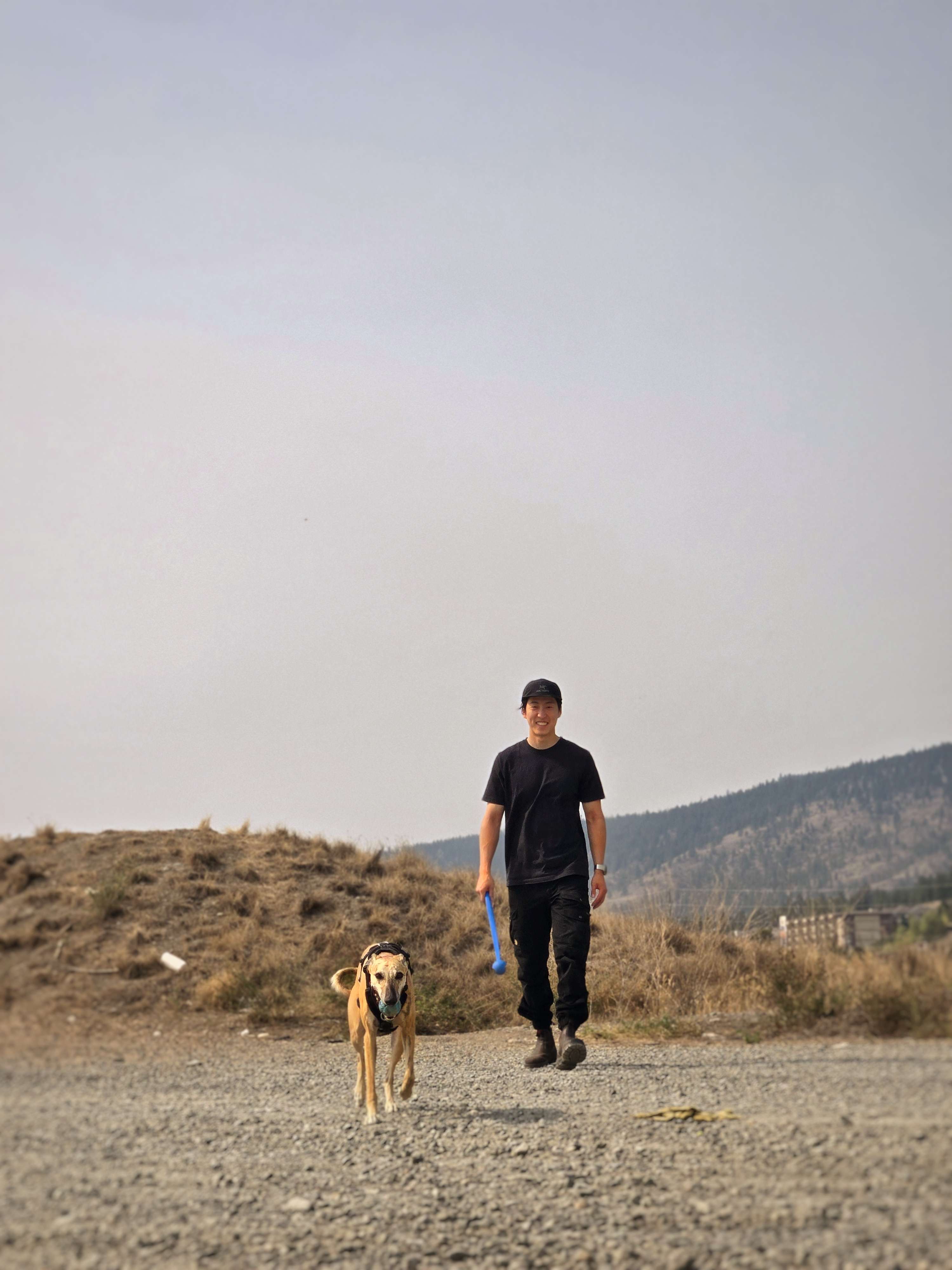 Sighthound Builders' founder outdoors with his greyhound, the inspiration for the company name